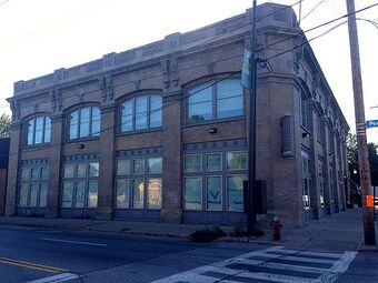 Image of a two-story brown brick square building