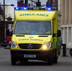 Mirror anamorphosis on the lower front of an ambulance, so the writing appears right way round in rear view mirrors of vehicles ahead of it in traffic