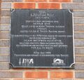 Plaque attached to retaining wall of Tom Rolt Bridge on mooring side of canal