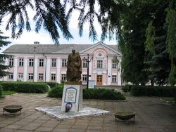 Soviet era memorial to those who perished in World War II in Voynyliv. Building of Professional Technical College of Voynyliv is on the back.