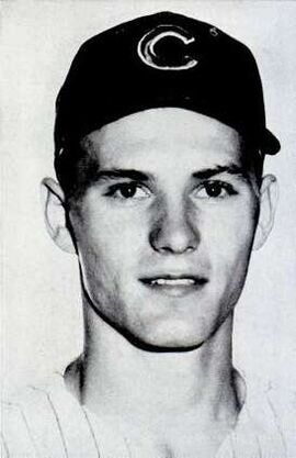 A black and white portrait photograph of a baseball player wearing a dark cap with a "C" on the center