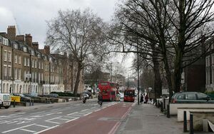 City Road as seen from Angel. A tree-lined street in winter with buses travelling in either direction.