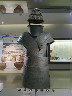 Bronze armour and a helmet with pieces of boar's tusk