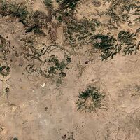 A satellite image of the volcano (center) and the surrounding area