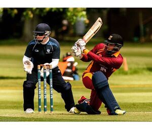 A colour photograph of a cricketer batting