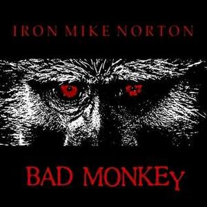 Black square with a picture of the eyes of a baboon with the words, Iron Mike Norton and Bad Monkey